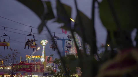 Amusement park and rides on a cloudy early evening. 4K UHD. Video stock 54268569