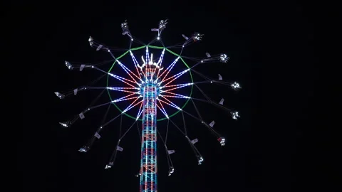 Amusement Park, Fair at Night. Multi Coloured Merry-Go-Round Rotating Fast. Video stock 197605038