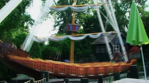 An amusement Park, a large swing in the form of a ship gently sways Vídeos de archivo 59156347