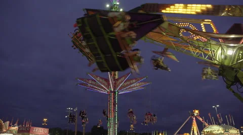 Amusement park ride on a cloudy early evening. 4K UHD. Stock Footage 54290700