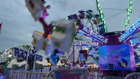 Amusement park, roller coaster and ferris wheel at sunset, in Dartmouth, Canada Stock Footage 255238403