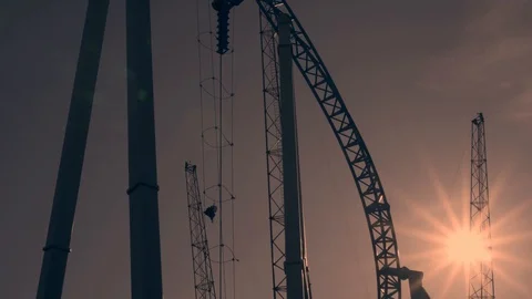 Amusement park visitors ride on Reverse Bungee. Sunset at amusement park. Stock Footage 128663374