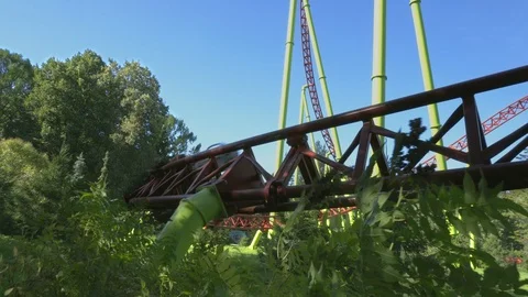 Amusement park visitors ride on roller coaster. Weekend activities. Stock-Footage 128663402