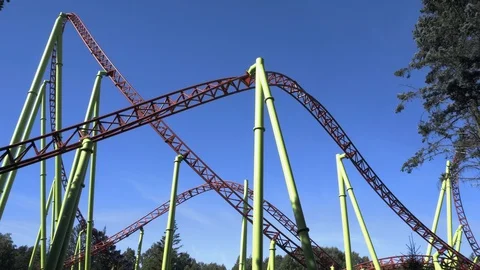Amusement park visitors ride on roller coaster. Weekend activities. Stock Footage 128663443