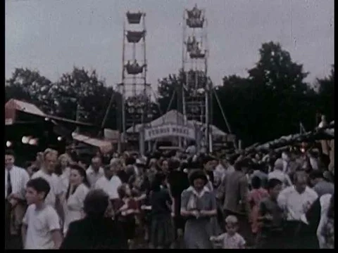 Amusement rides and a fire eater at a town fair. Stock Footage 75190845