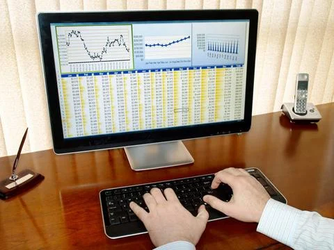 Analizing data on computer Male hands on the keyboard in front of computer... Stock Photos