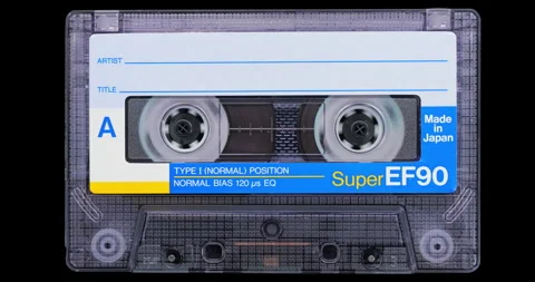 Analog cassette tape with labeled shell and twin reels in closeup Stock Footage 344996669