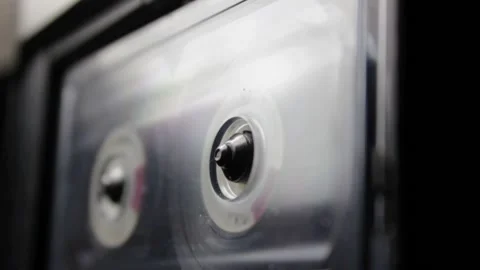  Analog cassette tape side view rotating in a player, close-up shot. Stock Footage 158245027