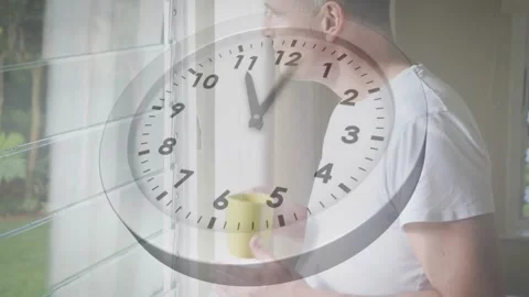 Analog clock advancing hour initiating man sipping coffee by window reflecting Video stock 318474815