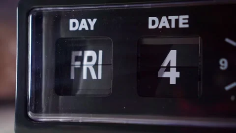 Analog clock face with flipping calendar display, dark setting, time passage Stock Footage 345289628