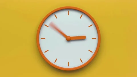 Analog clock hands spinning fast against a yellow background Video stock 333835996