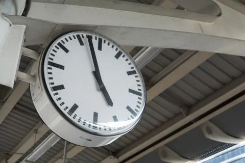 Analog clock at metro train station in daytime Stock Photos