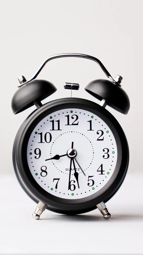 Analog clock. Time lapse of black and white vintage alarm clock 動画素材 330768719