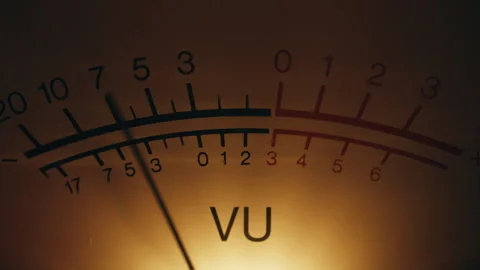 Analog dial indicator of audio signal level closeup. Vintage arrow moving inside Stock Footage 332623046