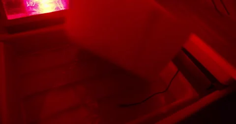 Analog photography print development using chemical trays in darkroom Stock Footage 328539567