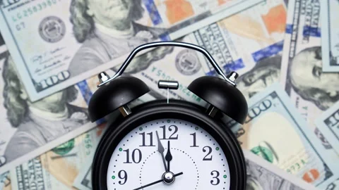 Analog wall clock on background of dollar banknotes. Business concept. Stock Footage 327449077
