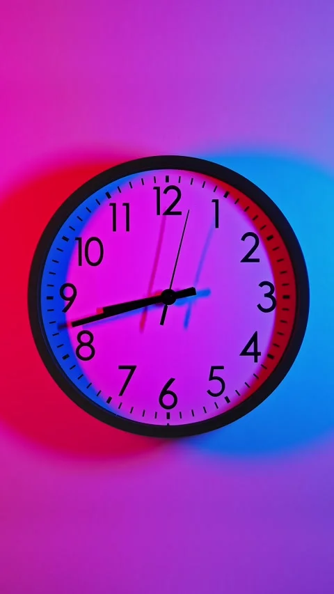 Analog wall clock. Time lapse wall clock with red and blue light. Clock running Stock Footage 303723549