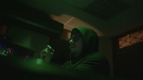 Analysing with a Pen, Hooded Computer Hacker or Programmer in Glasses Worki.. Stock Footage 234139920