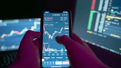 Analysis and study of financial markets on the screen of a mobile phone. Stock Footage 231415607