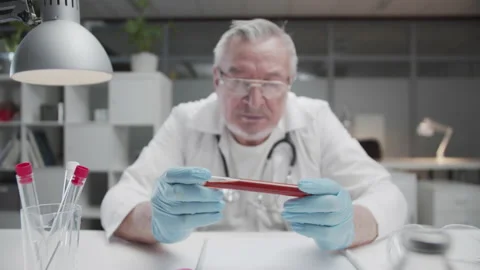 Analysis of a blood sample in a test tube in the hands of an experienced doctor Stock Footage 151864933