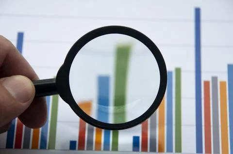 Analysis of data, chart and graphs using magnifying glass. Business finance.. Stock Photos