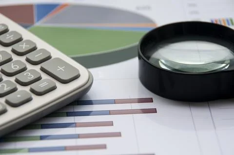 Analysis of data, chart and graphs with calculator and magnifying glass. Bu.. Stock Photos