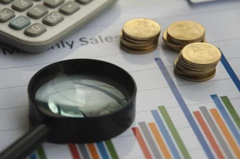 Analysis of data, chart and graphs with calculator, magnifying glass and go.. Stock Photos