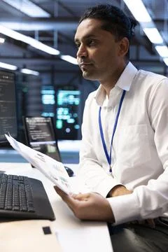 Analysis, IT professional and report in close up at data center Stock Photos