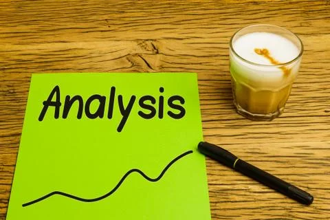 Analysis text on green paper with graph. Marker and coffee on desk. Stock Photos