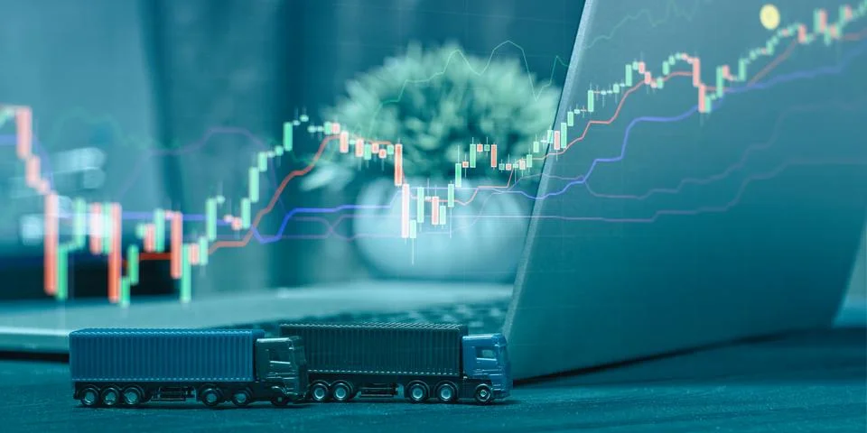 Analysis Workspace Featuring Candlestick Chart on Laptop, Miniature Toy Truck Foto stock