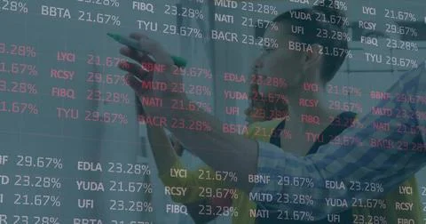 Analyst annotating transparent board in office, with green marker and financial Stock Photos
