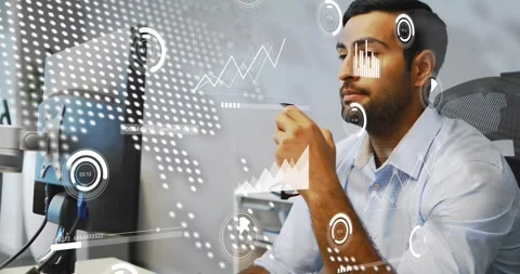 Analyst at desk acting on data alert, analyzing monitor while HUD overlays Video stock 334114050
