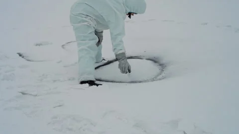 Analyst explores snowcovered field for samples. Exploration specialist Video stock 342743233