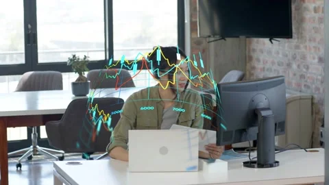 Analyst glancing at peer and speaking, calling up 3D hologram graph over laptop Stock Footage 333463432