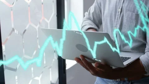 Analyst opening and angling laptop at hex window making teal graph shift showing Stock Footage 335317327