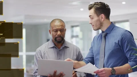 Analyst pointing to laptop and docs showing tech data senior reading laptop as Stock Footage 333526383