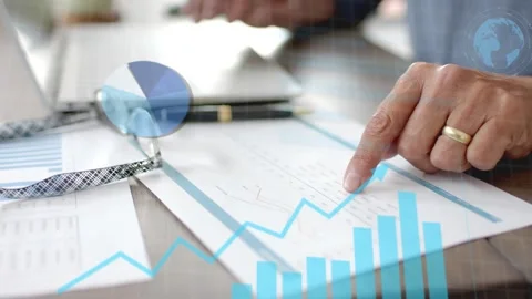 Analyst pointing at printed charts and sliding card, activating blue finance Stock Footage 335739561