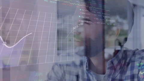 Analyst sitting behind glass getting live finance data monitoring projected Stock Footage 332577518