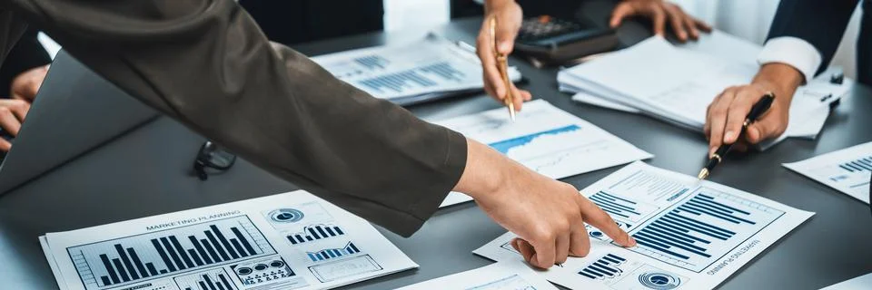 Analyst team analyzing business data paper on office table. Prodigy Stock Photos