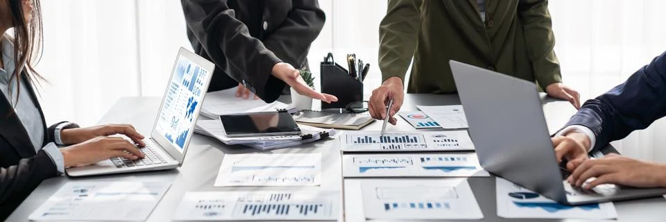 Analyst team analyzing business data paper on office table. Prodigy Stock Photos