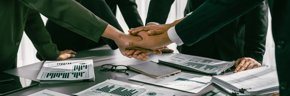 Analyst team put hand stack together with pile of BI paper. Prodigy 스톡 사진