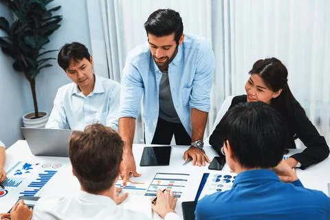 Analyst team utilizing BI Fintech to analyze financial data at table. Prudent Stock Photos