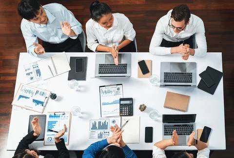 Analyst team utilizing BI Fintech to analyze financial data at table. Prudent Stock Photos