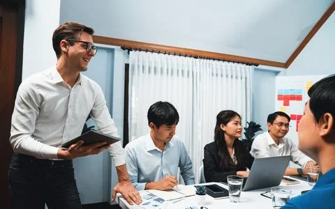 Analyst team utilizing BI Fintech to analyze financial data at table. Prudent Stock Photos