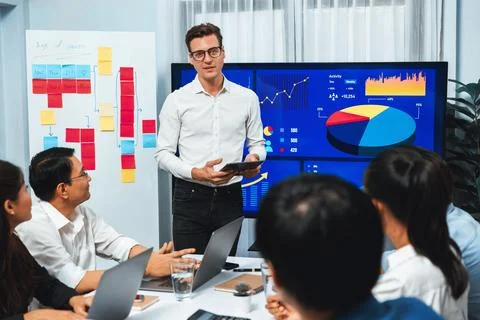 Analyst team utilizing BI Fintech to analyze financial data at table. Prudent Stock Photos