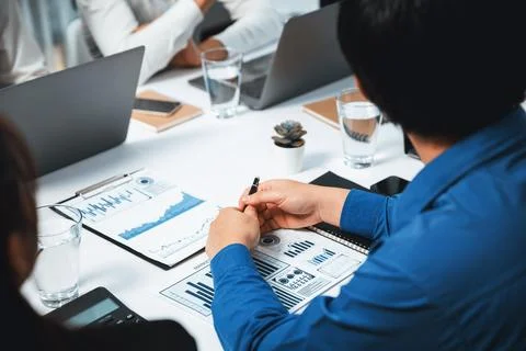 Analyst team utilizing BI Fintech to analyze financial data at table. Prudent Stock Photos