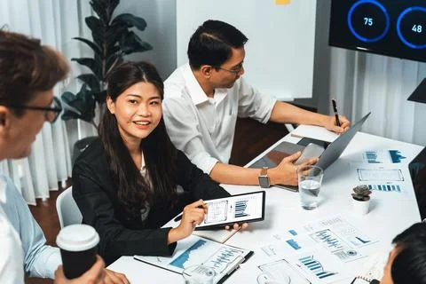 Analyst team utilizing BI Fintech to analyze financial data at table. Prudent Stock Photos