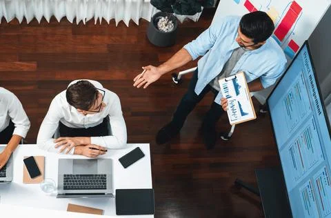 Analyst team utilizing BI Fintech to analyze financial data at table. Prudent Stock Photos