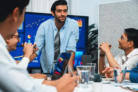 Analyst team utilizing BI Fintech to analyze financial data at table. Prudent Stock Photos