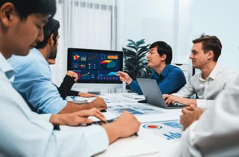 Analyst team utilizing BI Fintech to analyze financial data at table. Prudent Stock Photos